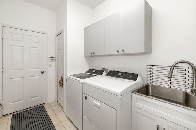 9101 Yarberry St, Sarasota, FL 34240 - washroom featuring cabinet space, separate washer and dryer, and light tile patterned floors
