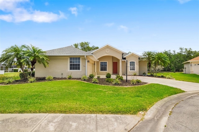 9101 Yarberry St, Sarasota, FL 34240 - single story home with a front lawn, concrete driveway, and stucco siding