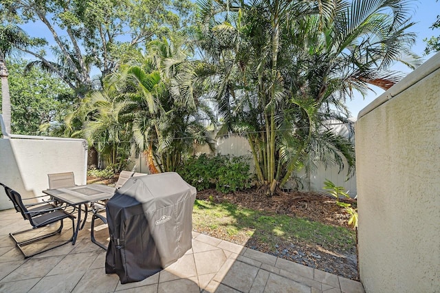 3405 54th Dr W Unit 102, Bradenton, FL 34210 - view of patio / terrace with outdoor dining area, a grill, and fence