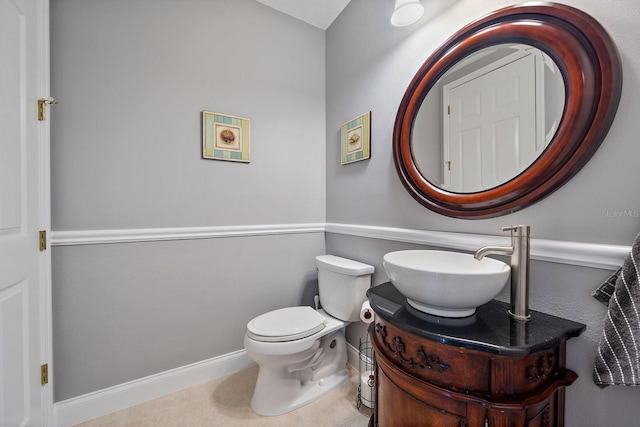 3405 54th Dr W Unit 102, Bradenton, FL 34210 - half bathroom with baseboards, vanity, tile patterned floors, and toilet
