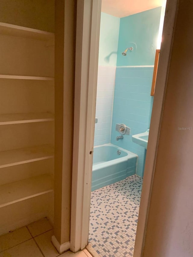full bathroom with shower / washtub combination and tile patterned flooring