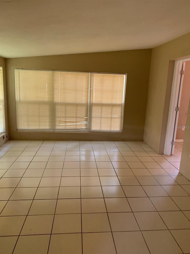 unfurnished room featuring light tile patterned floors