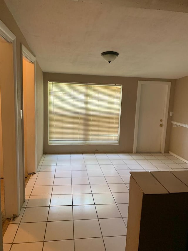 unfurnished room featuring light tile patterned floors