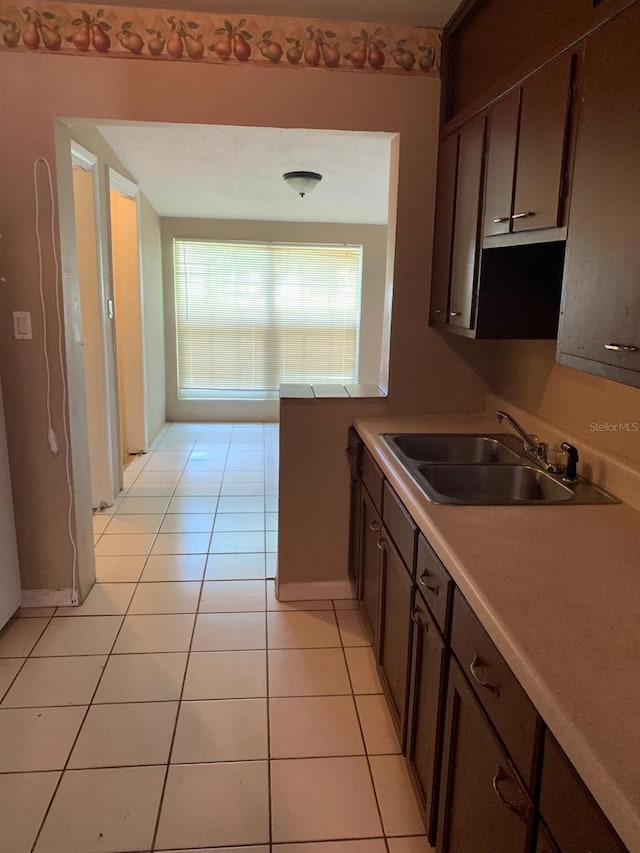 21266 Coulton Ave, Port Charlotte, FL 33952 - kitchen with light tile patterned floors, light countertops, and dark brown cabinets