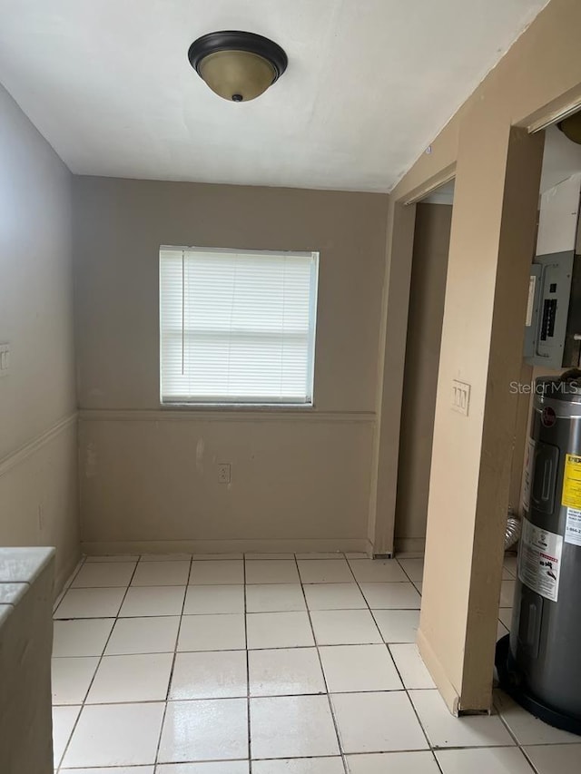 21291 Coulton Ave, Port Charlotte, FL 33952 - spare room with electric water heater, electric panel, and light tile patterned flooring