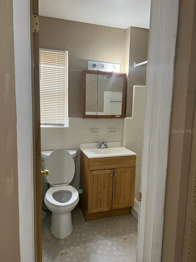 21291 Coulton Ave, Port Charlotte, FL 33952 - bathroom featuring tile walls, vanity, and a shower
