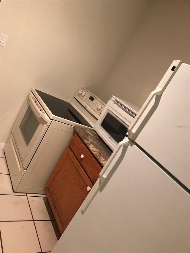 21291 Coulton Ave, Port Charlotte, FL 33952 - washroom featuring washer and clothes dryer and light tile patterned flooring