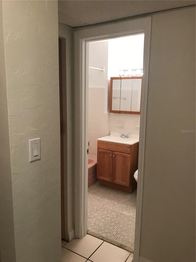21291 Coulton Ave, Port Charlotte, FL 33952 - full bath featuring vanity, a tub, and tile patterned floors