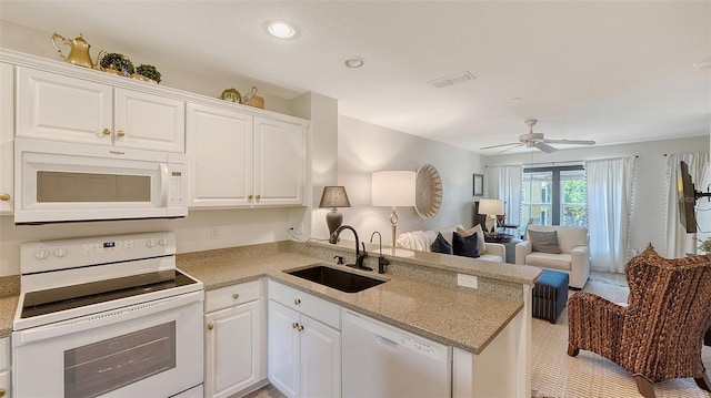 9008 White Sage Loop Unit 3605, Lakewood Ranch, FL 34202 - kitchen featuring a peninsula, white cabinetry, a sink, and white appliances