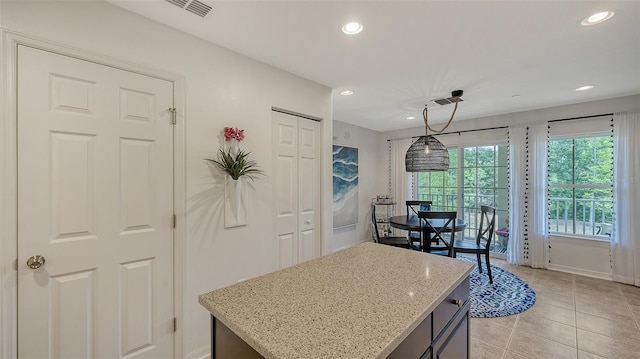 9008 White Sage Loop Unit 3605, Lakewood Ranch, FL 34202 - kitchen with hanging light fixtures, baseboards, light stone countertops, light tile patterned flooring, and recessed lighting