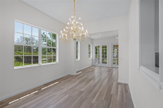 5821 Valente Pl, Sarasota, FL 34238 - unfurnished dining area with baseboards, a notable chandelier, and plenty of natural light