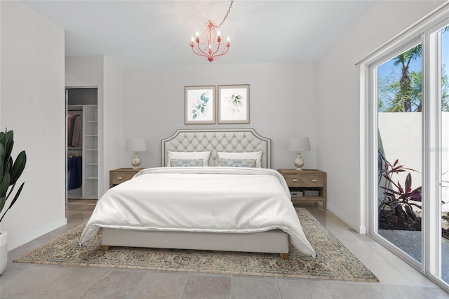 5821 Valente Pl, Sarasota, FL 34238 - bedroom with access to exterior, a walk in closet, a chandelier, and baseboards
