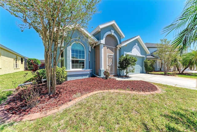 ranch-style home featuring stucco siding, a front lawn, driveway, and a garage