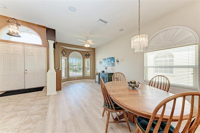 dining space featuring ceiling fan with notable chandelier, decorative columns, visible vents, and light wood-type flooring