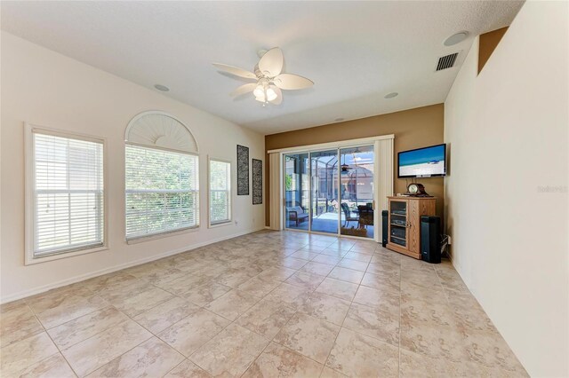spare room featuring baseboards, a ceiling fan, and visible vents