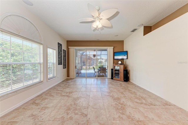 interior space with visible vents and ceiling fan