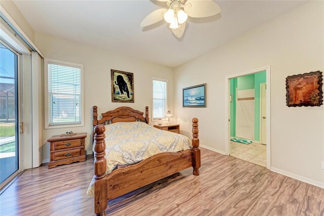 bedroom featuring multiple windows, baseboards, wood finished floors, and access to exterior