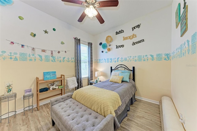 bedroom featuring ceiling fan, baseboards, and wood finished floors