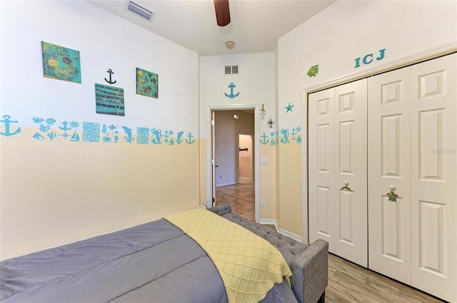 bedroom with a closet, visible vents, a ceiling fan, and light wood finished floors