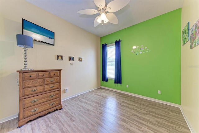 bedroom featuring light wood-style floors and baseboards