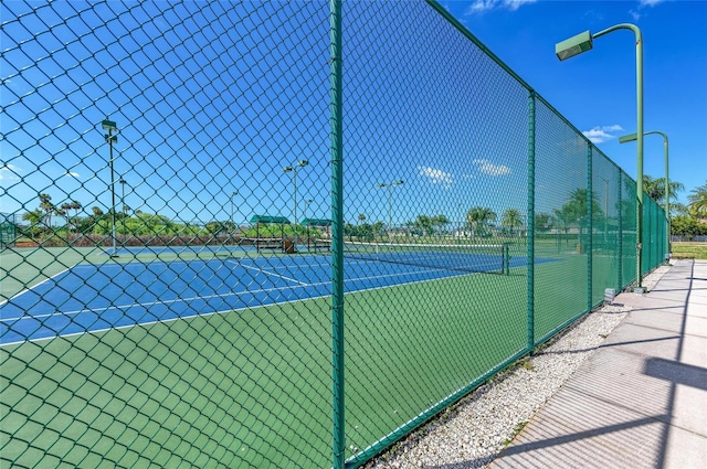 view of tennis court with fence