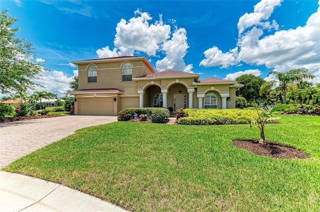 12838 Daisy Pl, Bradenton, FL 34212 - mediterranean / spanish-style home with a garage, stucco siding, decorative driveway, and a front yard