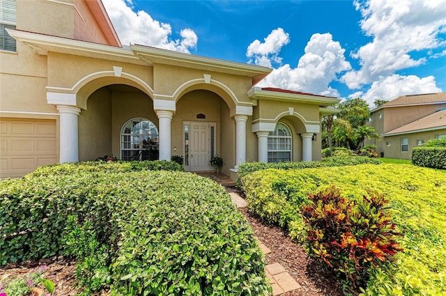 12838 Daisy Pl, Bradenton, FL 34212 - doorway to property featuring stucco siding and a garage