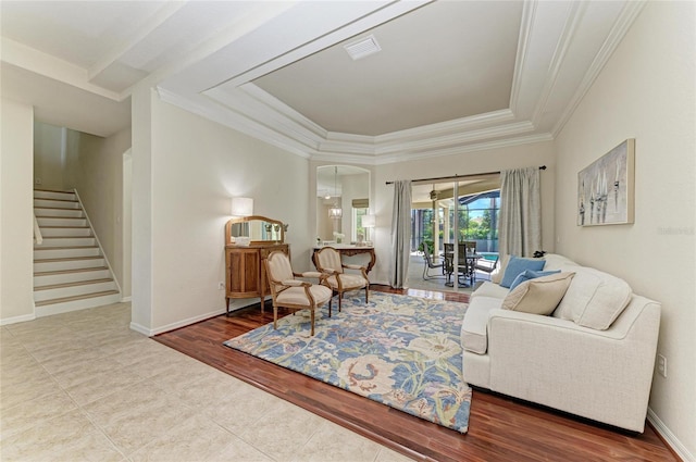 12838 Daisy Pl, Bradenton, FL 34212 - living room with crown molding, stairs, a tray ceiling, wood finished floors, and arched walkways