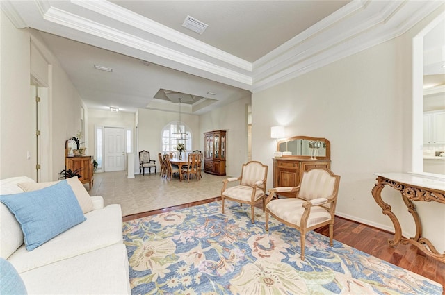 12838 Daisy Pl, Bradenton, FL 34212 - living area featuring a raised ceiling, ornamental molding, wood finished floors, and a chandelier