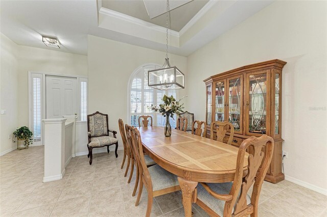 12838 Daisy Pl, Bradenton, FL 34212 - dining area featuring a chandelier, light tile patterned floors, crown molding, and a tray ceiling