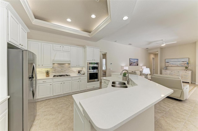 12838 Daisy Pl, Bradenton, FL 34212 - kitchen featuring stainless steel appliances, open floor plan, custom exhaust hood, backsplash, and light tile patterned floors