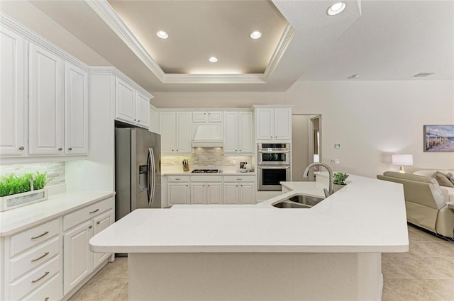 12838 Daisy Pl, Bradenton, FL 34212 - kitchen with appliances with stainless steel finishes, open floor plan, custom exhaust hood, decorative backsplash, and a spacious island