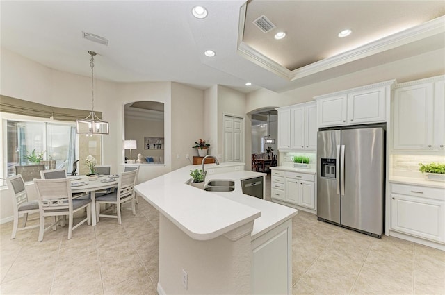 12838 Daisy Pl, Bradenton, FL 34212 - kitchen with stainless steel appliances, arched walkways, light countertops, ornamental molding, and recessed lighting