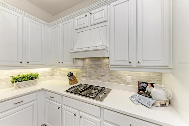 12838 Daisy Pl, Bradenton, FL 34212 - kitchen with stainless steel gas stovetop, white cabinetry, and tasteful backsplash
