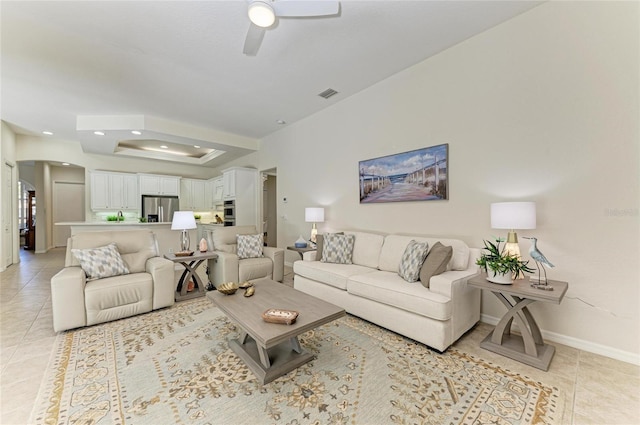 12838 Daisy Pl, Bradenton, FL 34212 - living room with light tile patterned flooring, a ceiling fan, arched walkways, a tray ceiling, and recessed lighting