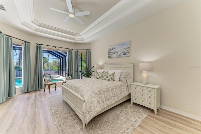 12838 Daisy Pl, Bradenton, FL 34212 - bedroom with a raised ceiling, light wood-style floors, crown molding, ceiling fan, and access to outside