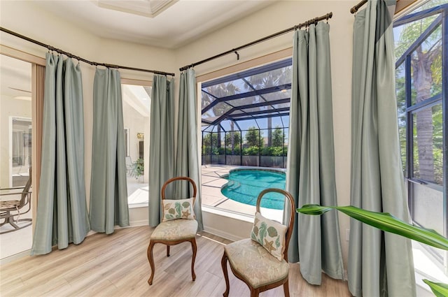 12838 Daisy Pl, Bradenton, FL 34212 - living area featuring wood finished floors, plenty of natural light, and a sunroom