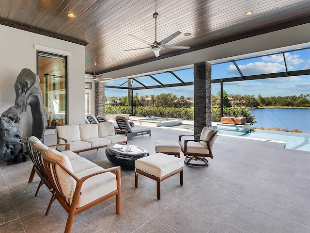 view of patio featuring ceiling fan, an outdoor hangout area, glass enclosure, an in ground hot tub, and an outdoor pool