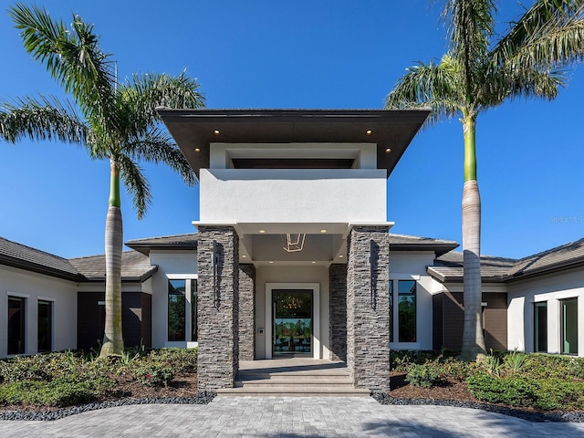 view of front of house with stucco siding and stone siding