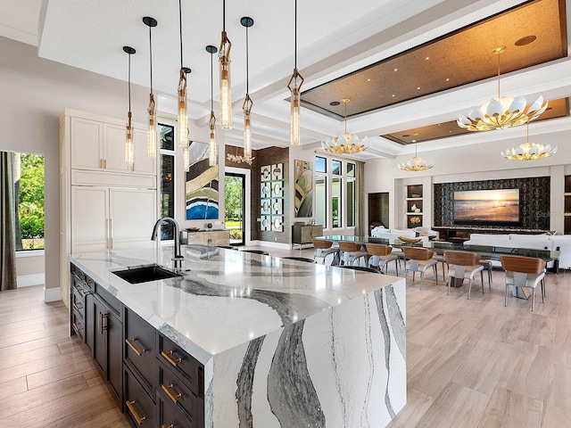 kitchen with a chandelier, open floor plan, and a sink