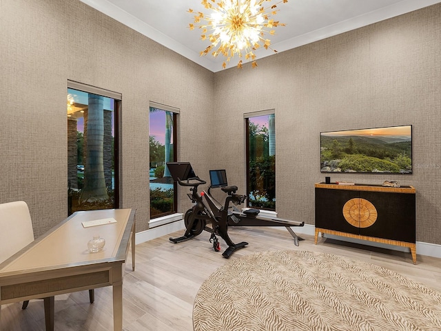 interior space with wood finished floors, an inviting chandelier, and a towering ceiling