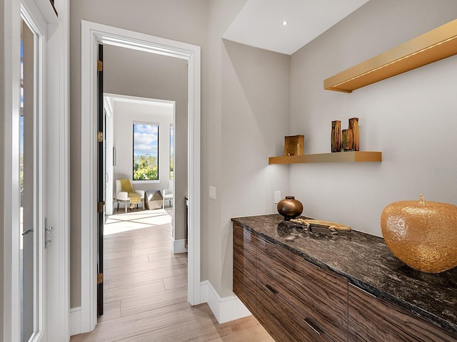 interior space with light wood-style floors and baseboards