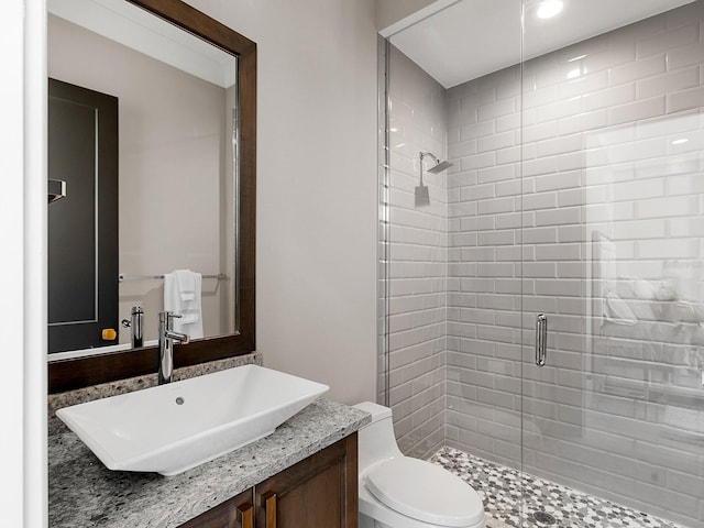full bath featuring a stall shower, toilet, and vanity