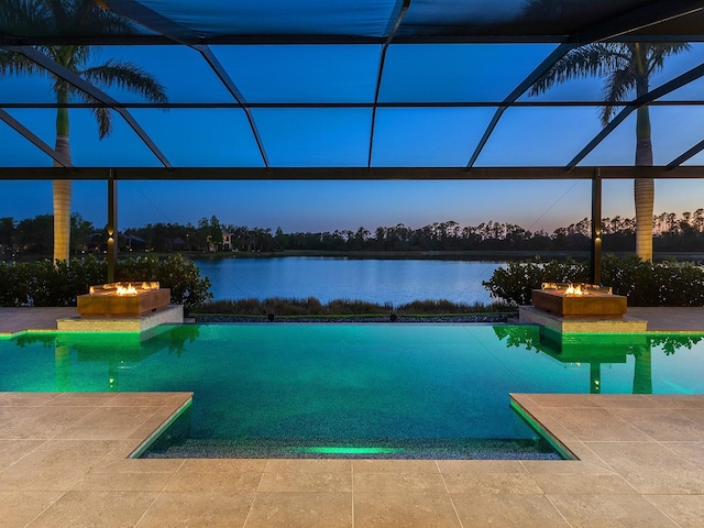 pool at dusk with an outdoor pool, a patio, and a jacuzzi