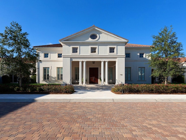 view of front of house featuring covered porch and stucco siding