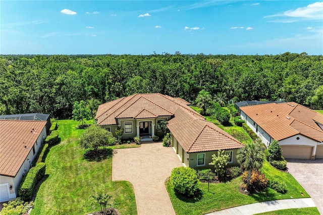 drone / aerial view featuring a view of trees