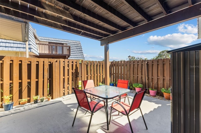 14519 Catalina Cir, Seminole, FL 33776 - view of patio / terrace featuring fence and outdoor dining area