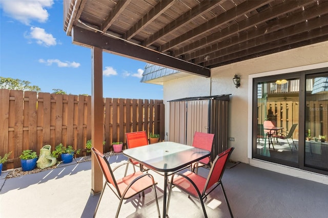 14519 Catalina Cir, Seminole, FL 33776 - view of patio / terrace featuring outdoor dining area and fence