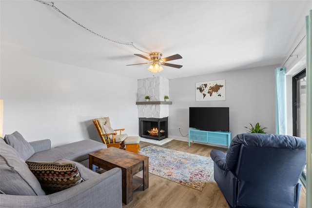 14519 Catalina Cir, Seminole, FL 33776 - living area with wood finished floors, a large fireplace, and ceiling fan