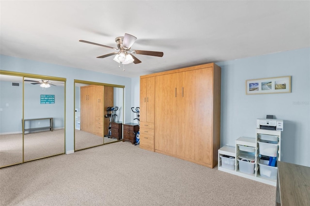 14519 Catalina Cir, Seminole, FL 33776 - carpeted bedroom featuring multiple closets, visible vents, and ceiling fan